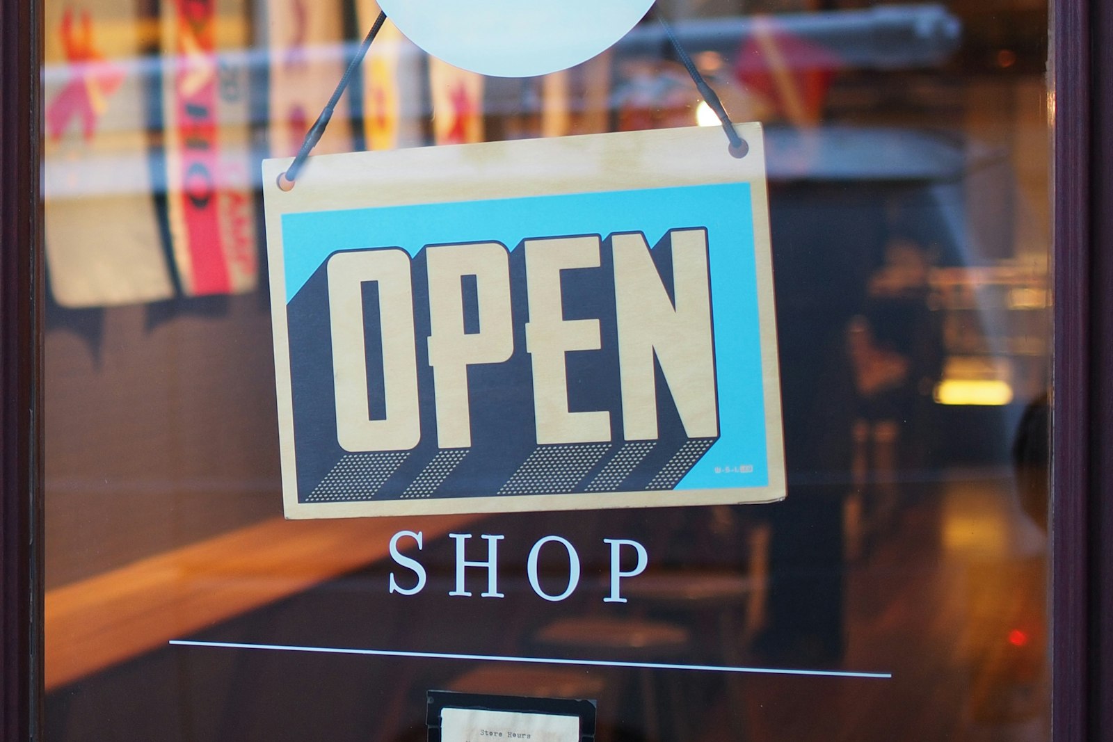 An open sign hanging in a small business doorway